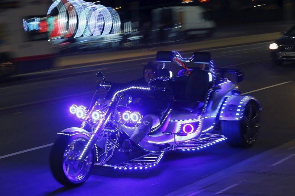 A man rides an illuminated trike during Diwali celebrations in Leicester