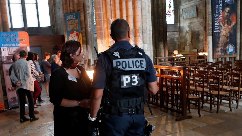 A police officer stands guard during a mass in tribute to priest Jacques Hamel in the Cathedral Notre Dame in Rouen, Normandy, France, Wednesday, July 27, 2016.