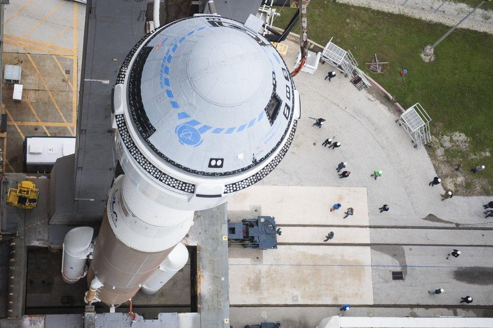 Starliner sits atop an Atlas V as they are rolled out to the launch pad ahead of a test flight in 2019