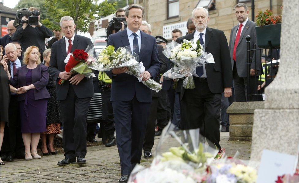 David Cameron and Jeremy Corbyn carrying flowers in tribute to Jo Cox