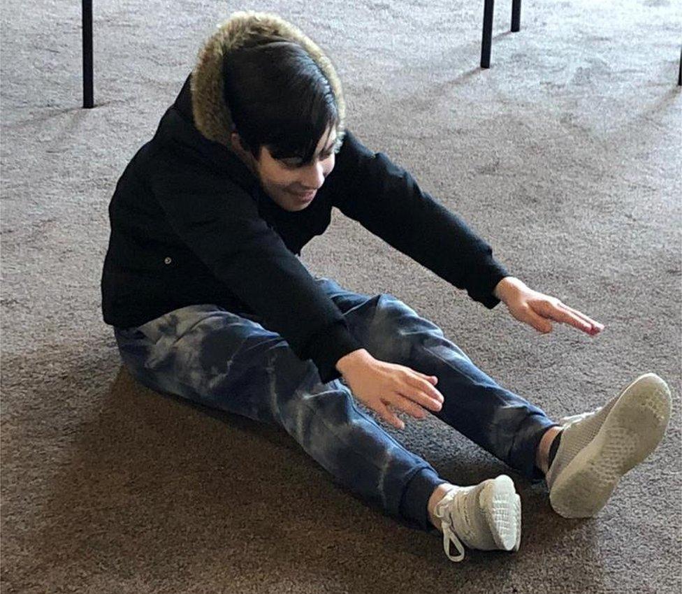 Mehdi stretching for his toes at the Sunday education support group