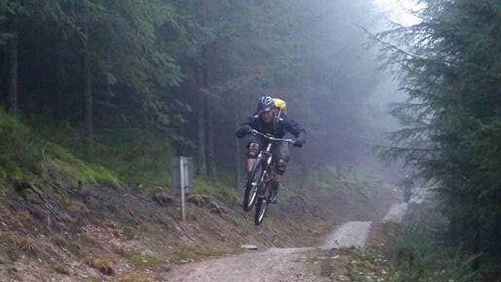 A rider lifts off along a trail at Llandegla mountain biking centre