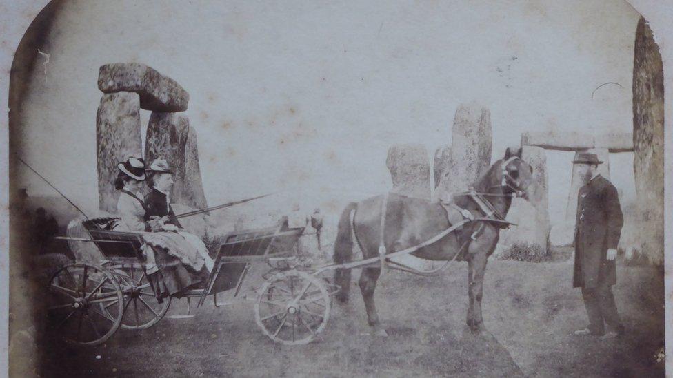 Family with horse drawn carriage at stonehenge