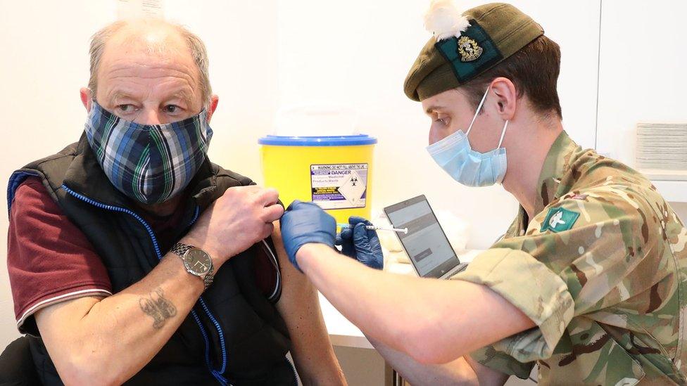 Derek Fraser from Edinburgh receives an injection of a coronavirus vaccine from military doctor Captain Robert Reid from 3 Medical Regiment who are assisting with the vaccination programme at the Royal Highland Showground near Edinburgh.