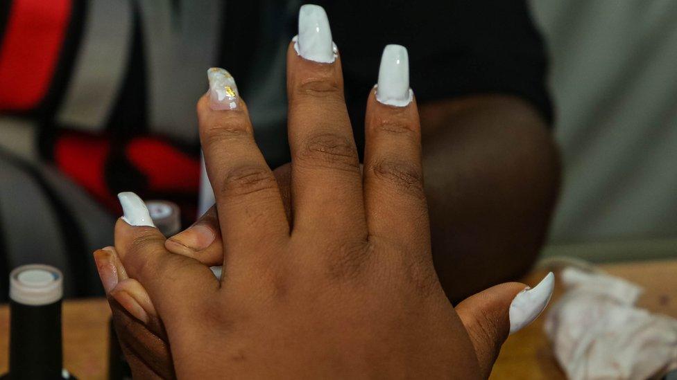 A woman with blue nail paint