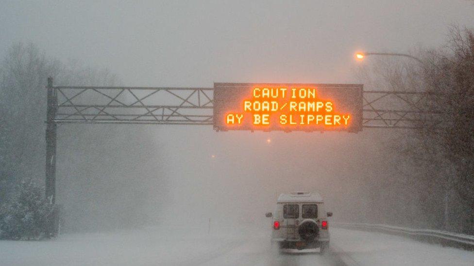 A van moves slowly on the Northern State Parkway