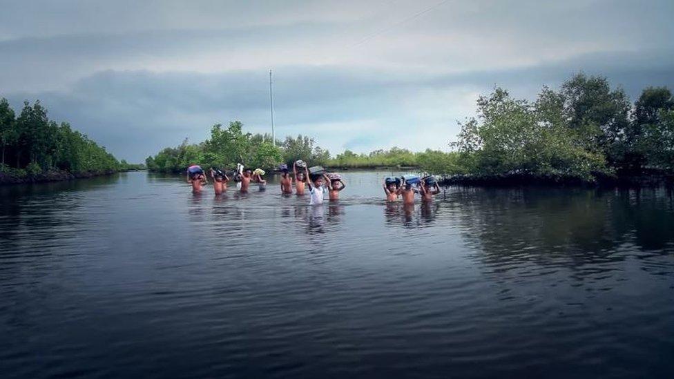 Group of children wading to school