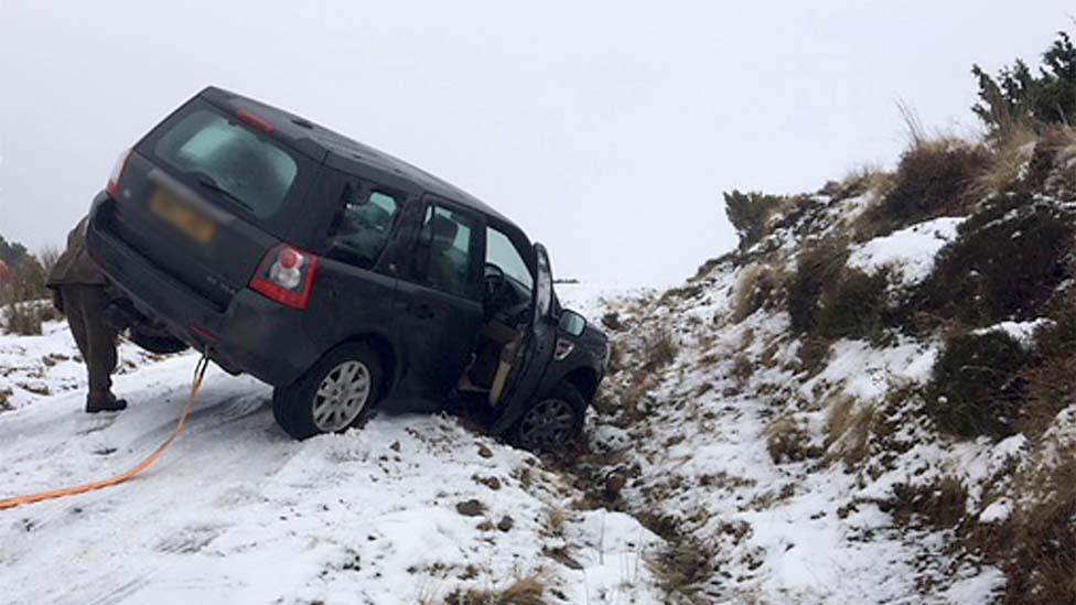 Car being towed from snowy ditch in Glenrothes