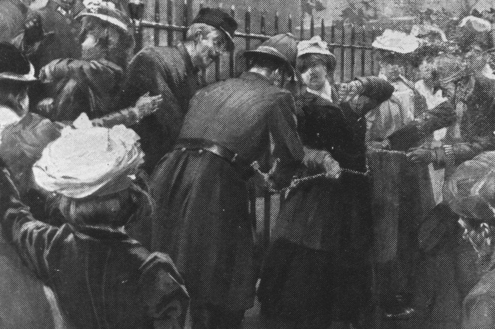 An image in the Illustrated London News shows policemen cutting the chains of suffragettes who attached themselves to the railings at Downing Street