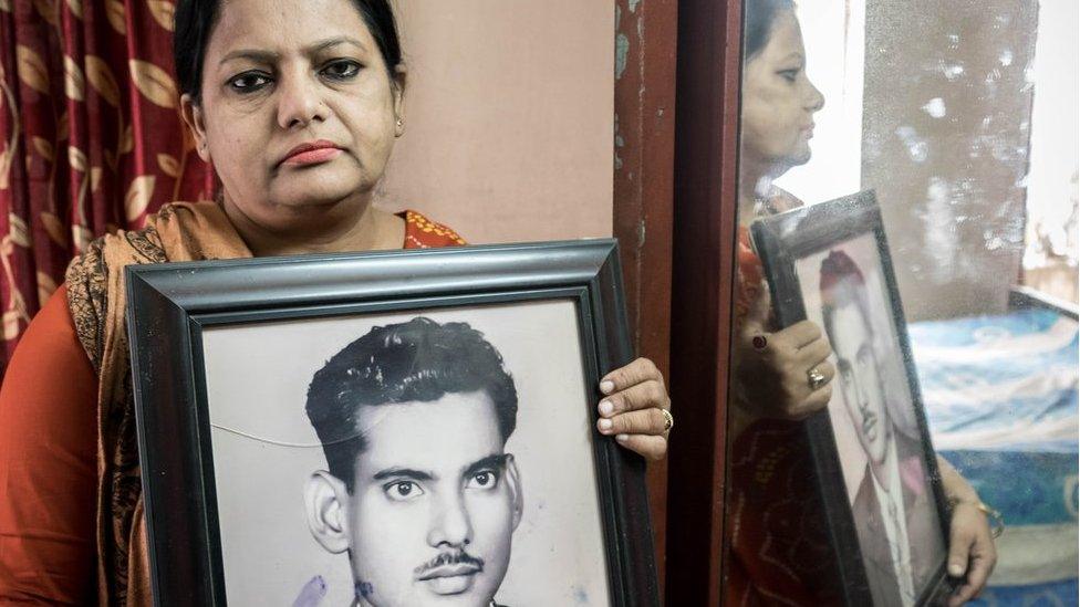 Suraya Parveen with a photo of her father Mejbah Uddin Ahmed