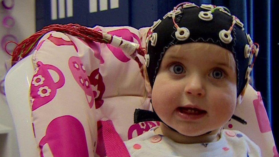 Baby with a brain scan cap