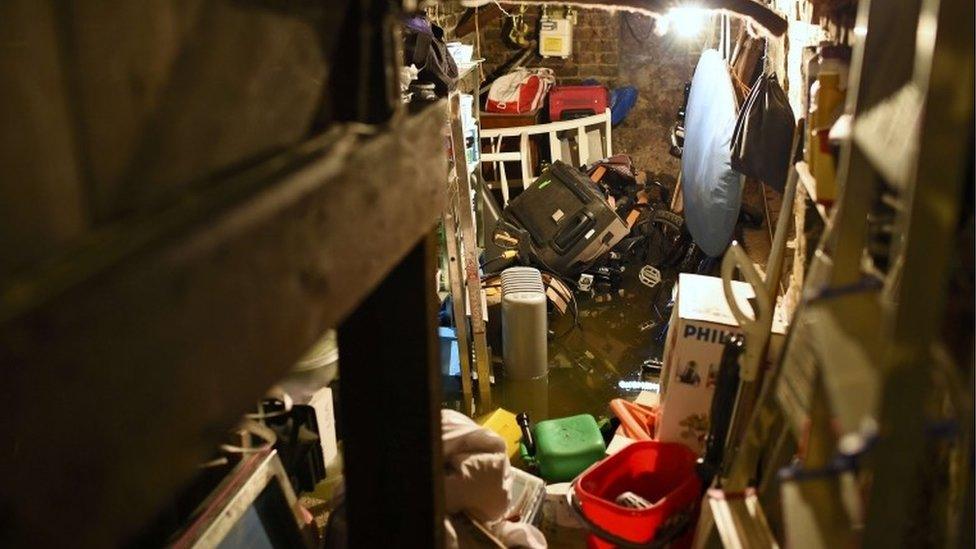 Floodwater engulfs objects in the cellar of house, after heavy rain in south London