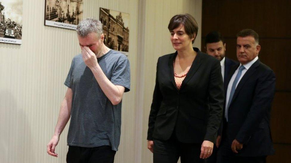 Canadian citizen, Kristian Lee Baxter, who was being held in Syria reacts as he walks next to Canadian Ambassador to Lebanon, Emmanuelle Lamoureux