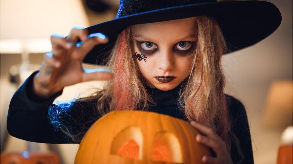 Girl dressed as a witch.