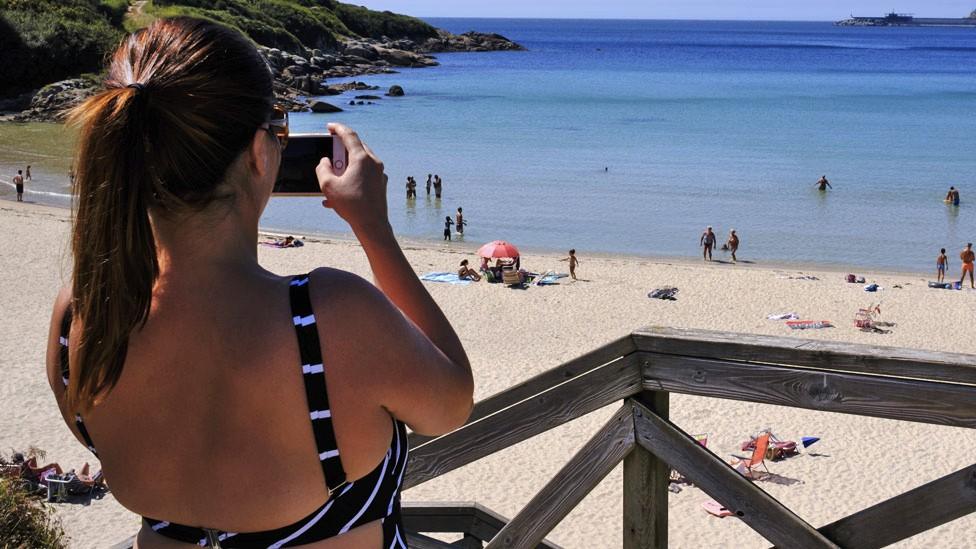 A tourist taking a photo in Spain