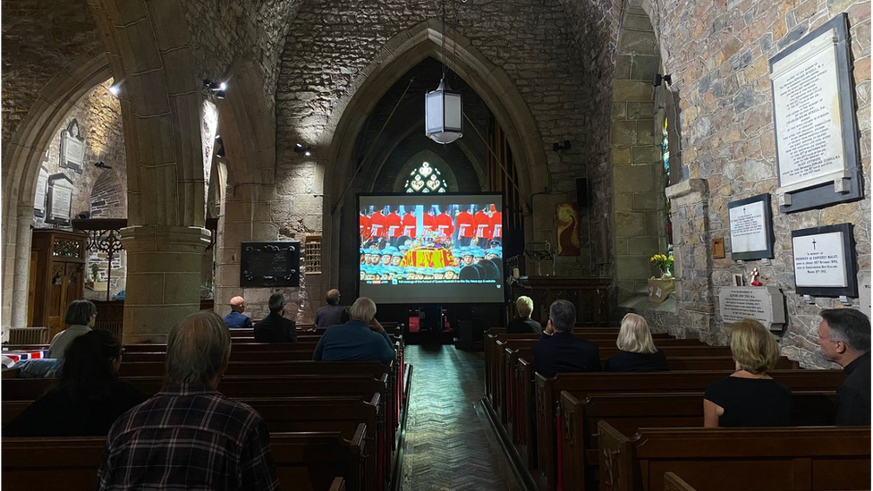 People watch the service at St Saviour Church