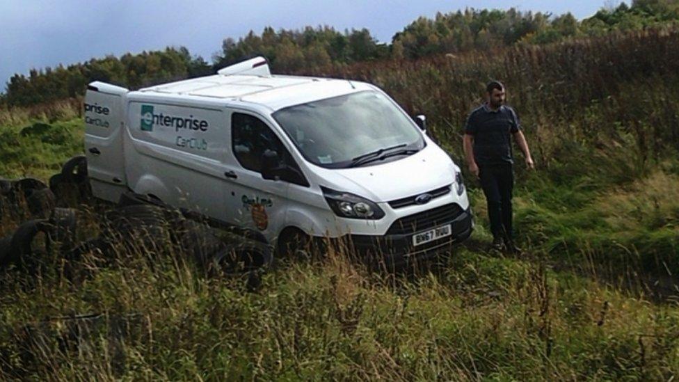 A camera catches Declan Clarke next to a hire van at Gartloch Farm, near Gartcosh, with tyres next to the van