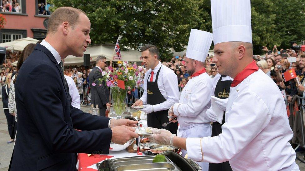 Prince William tastes traditional Polish dumplings on the second day of a tour of Poland