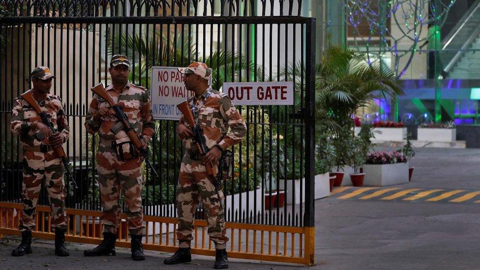 Three members of the Indo-Tibetan Border Police (ITBP) stand outside the BBC offices.