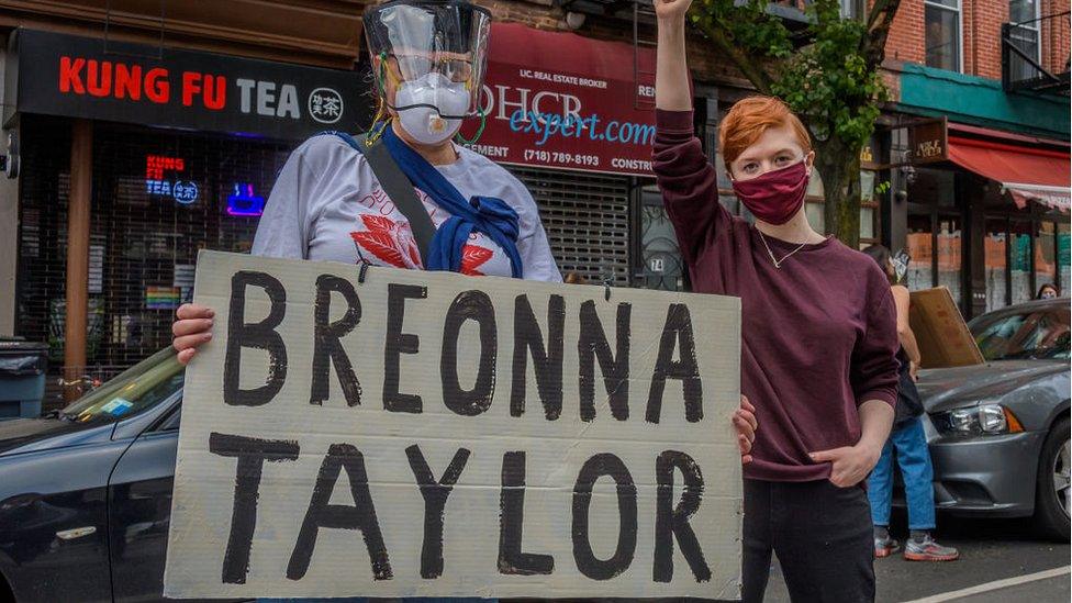 Protestors holding up sign with Breonna Taylor's name