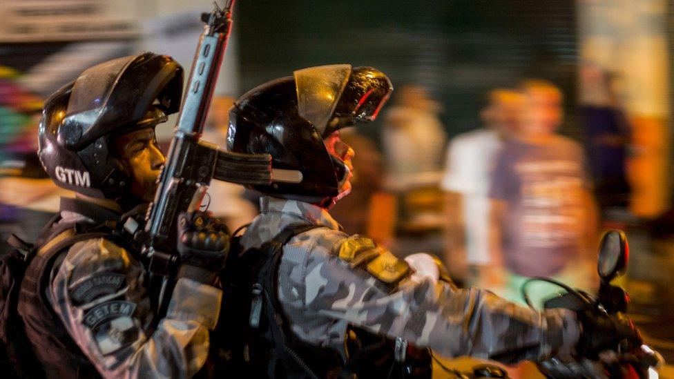 Police officers patrol the streets during a gathering of supporters of the left-wing presidential candidate for the Workers Party (PT), Fernando Haddad, in Rio de Janeiro, Brazil, after the far-right candidate Jair Bolsonaro won Brazil"s presidential election, in Rio de Janeiro, Brazil, on October 28, 2018