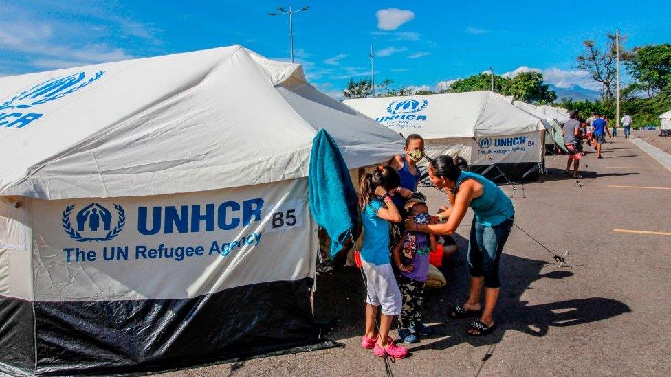 Venezuelan migrants exit a tent set up at the Tienditas International Bridge in Cucuta, Colombia, on the border with Venezuela, set up for Venezuelans who have been waiting at the Simon Bolivar International Bridge