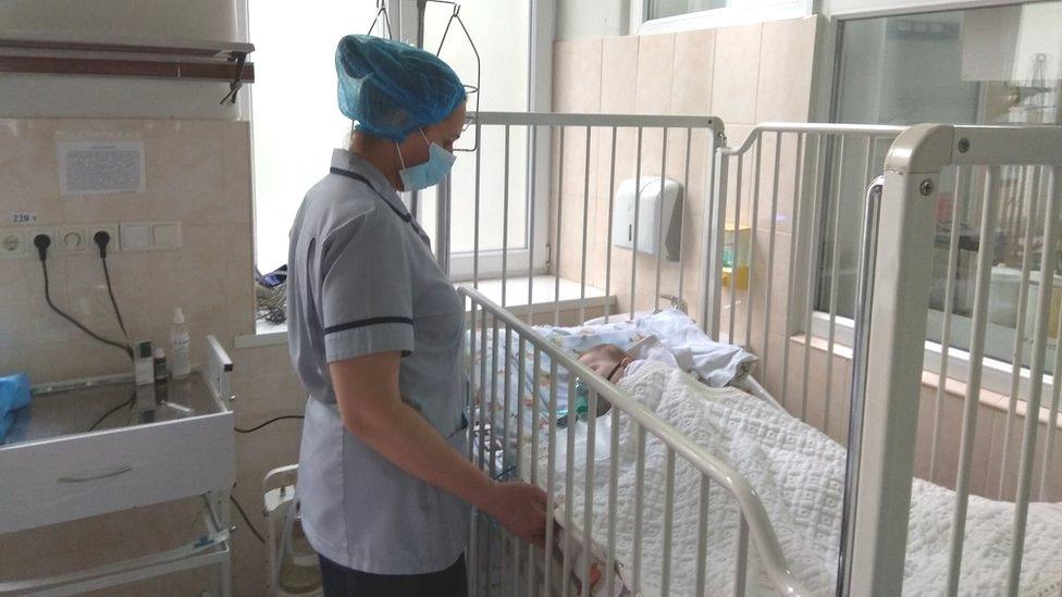 Nurse with child being treated for Measles