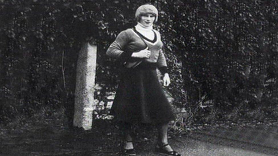 A male Avon and Somerset Police officer dressed as a woman with a dark skirt and handbag