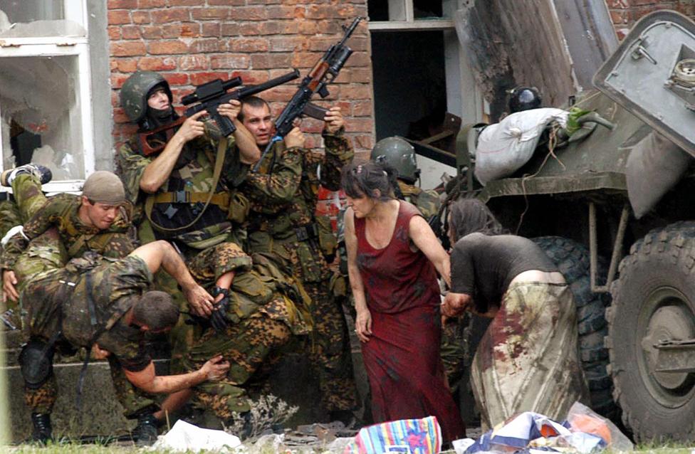 Soldiers and escaped hostages outside the school on the third day of the siege