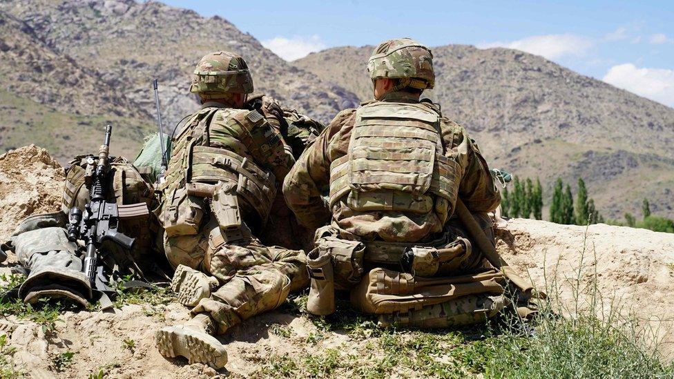 US soldiers look out over hillsides during a visit of the commander of US and NATO forces in Afghanistan on 6 June 2019