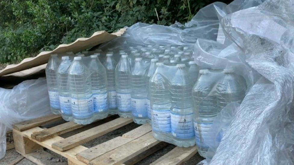 Bottled water on a pallet at a village hall