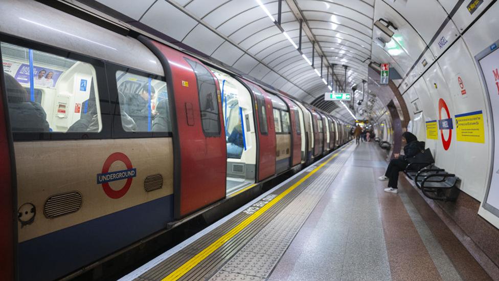 People wait for an underground ahead of the strike of underground workers, 1 April 2024