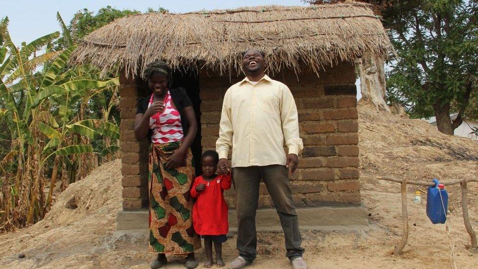 Villagers standing in front of a newly built lavatory