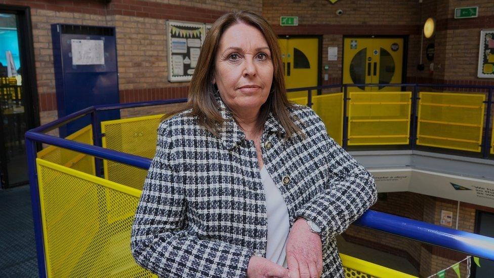 Penni Allen, Safeguarding lead at Chesterfield High School, leans on a railing and looks at camera