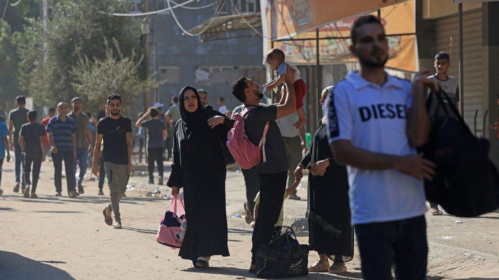 Residents in the Gaza Strip flee their homes to move away from the border with Israel after barrages of rockets were fired from the coastal enclave into Israel on October 7, 2023.