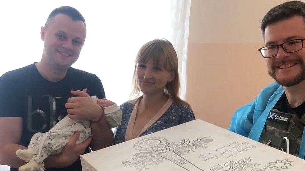 New parents in Ukraine with their new baby and baby box