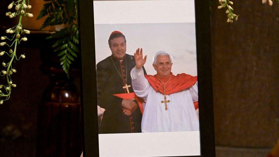 A framed photograph showing Cardinal George Pell with Pope Benedict XVI is seen on display at St Patrick's Cathedral