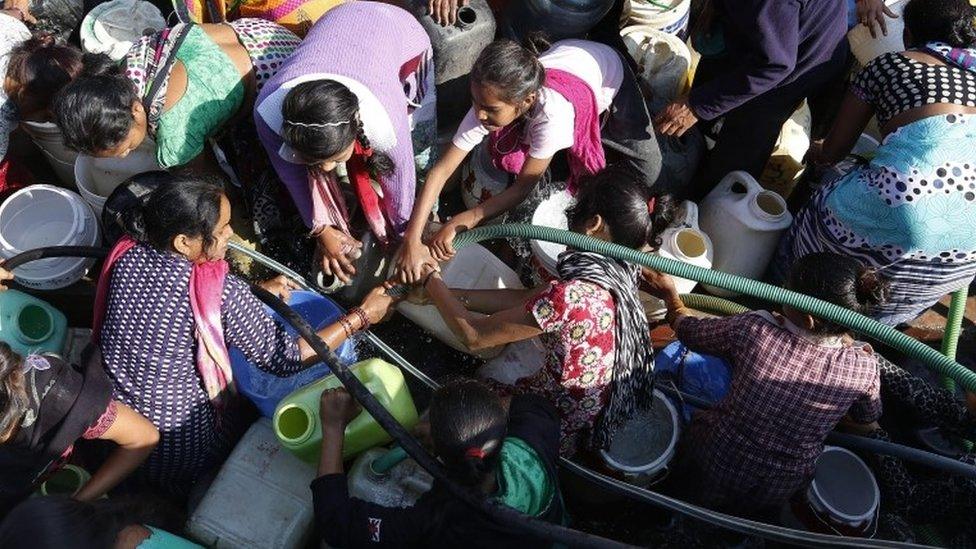 Indian people fill up canisters and containers with water from a tanker in New Delhi, India, 22 February 2016.
