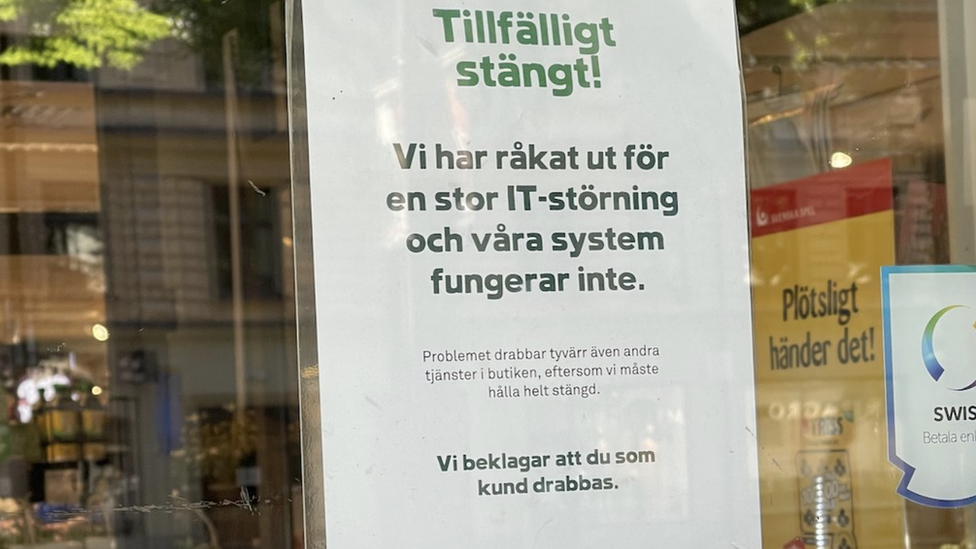 A sign on one of the shut Coop shops in Sweden says the company has been hit by "a large IT disturbance"