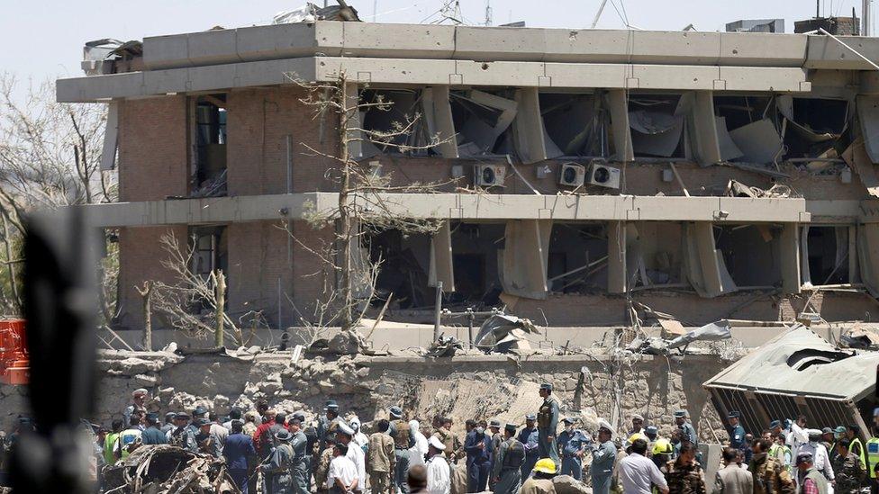 Afghan officials inspect outside the German embassy after a blast in Kabul, Afghanistan 31 May 2017