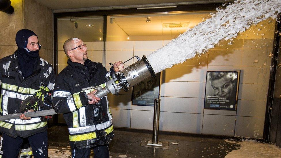 Firemen spray firefighting foam in Belgium