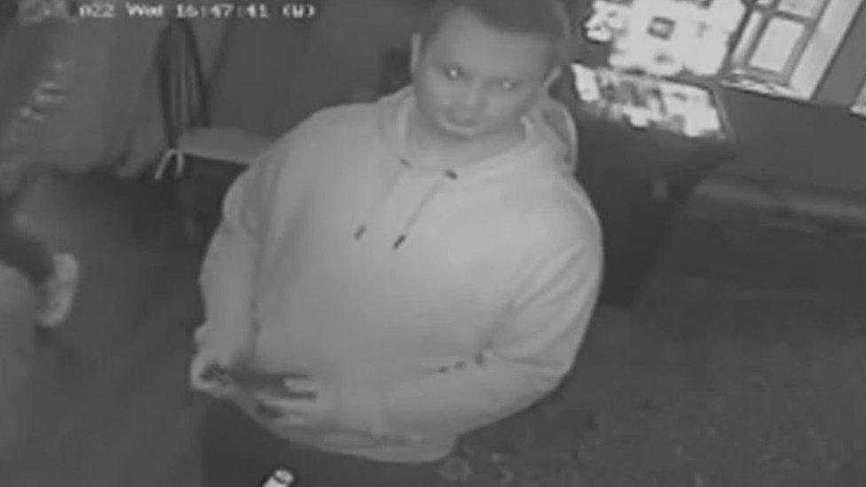 A CCTV screengrab of a man in a hoodie