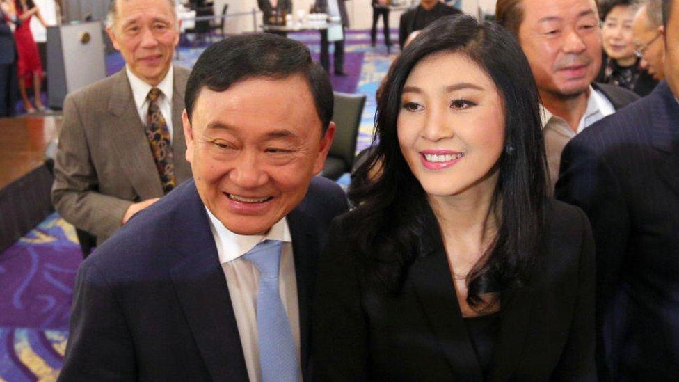 Former Thai prime ministers Thaksin Shinawatra (L) and his sister Yingluck Shinawatra (R)