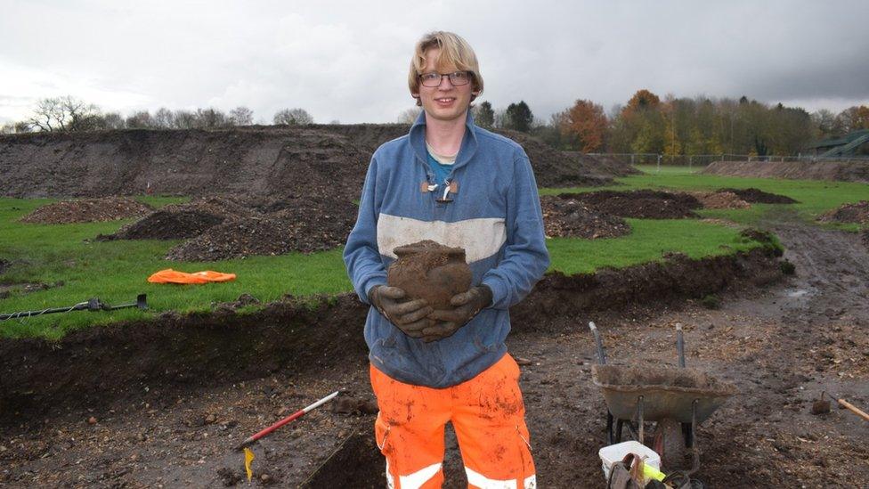 Archaeologist holding a pot