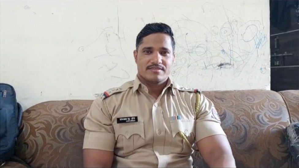 Somnath Zende seen in his police uniform at his home