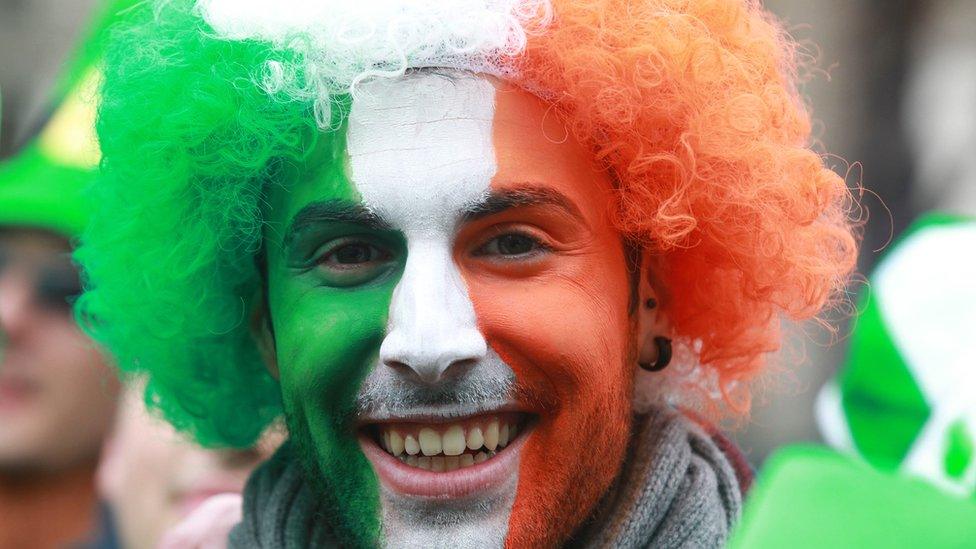 A man with his face painted in the colours of the Irish flag attends St Patrick's Day celebrations in Dublin