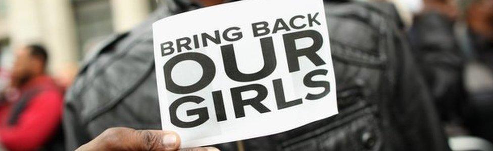 Protestor with a sign to save the schoolgirls