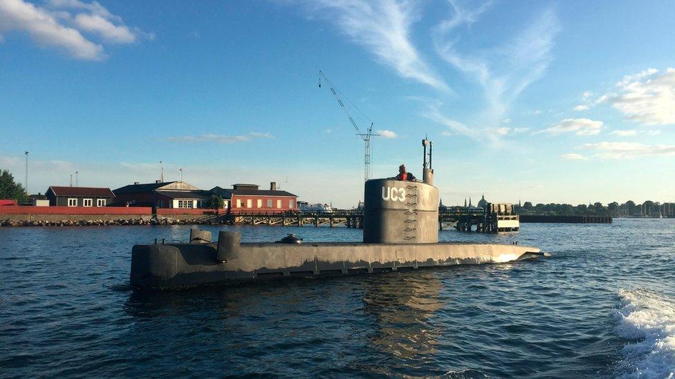 The submarine "UC3 Nautilus", with Kim Wall looking out of the top, is pictured in Copenhagen Harbour