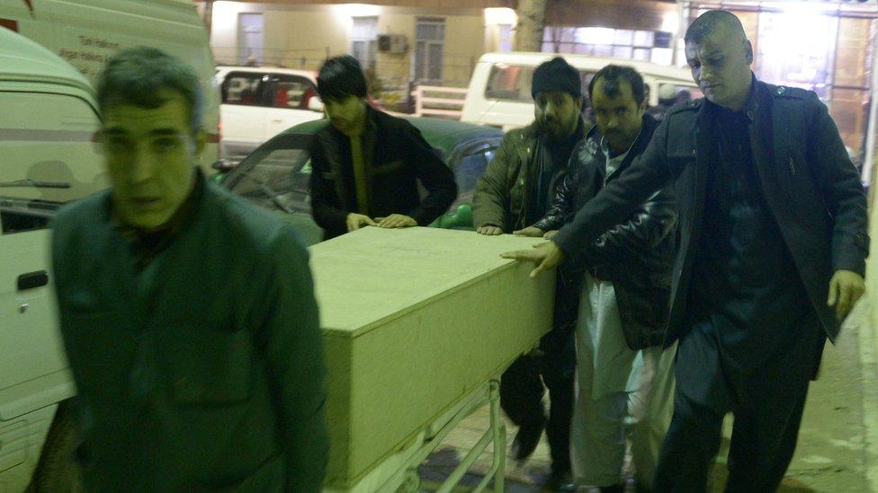 Men unload coffin of an ICRC employee killed by gunmen in Jowzjan province at a hospital in Mazar-i-Sharif, Afghanistan February 8, 2017