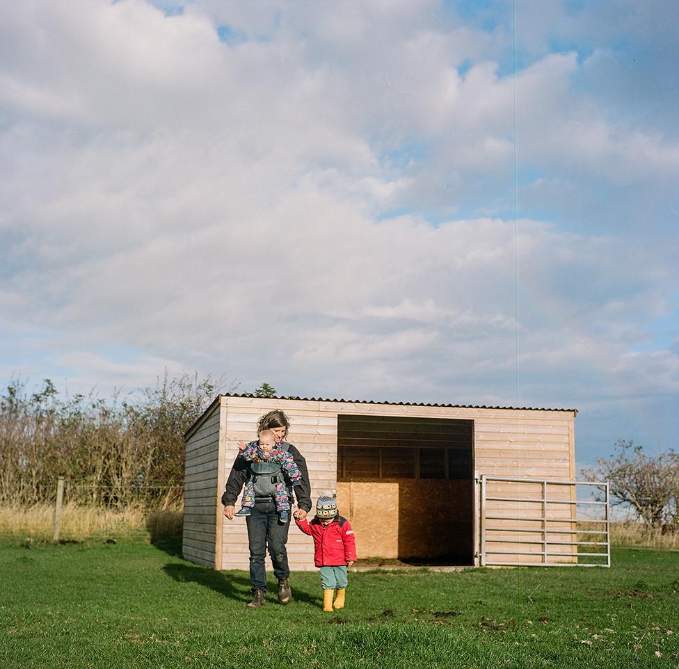 Anna works on her farm with her children in north Northumberland